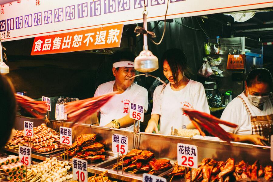 Vendors selling food at a street food stall